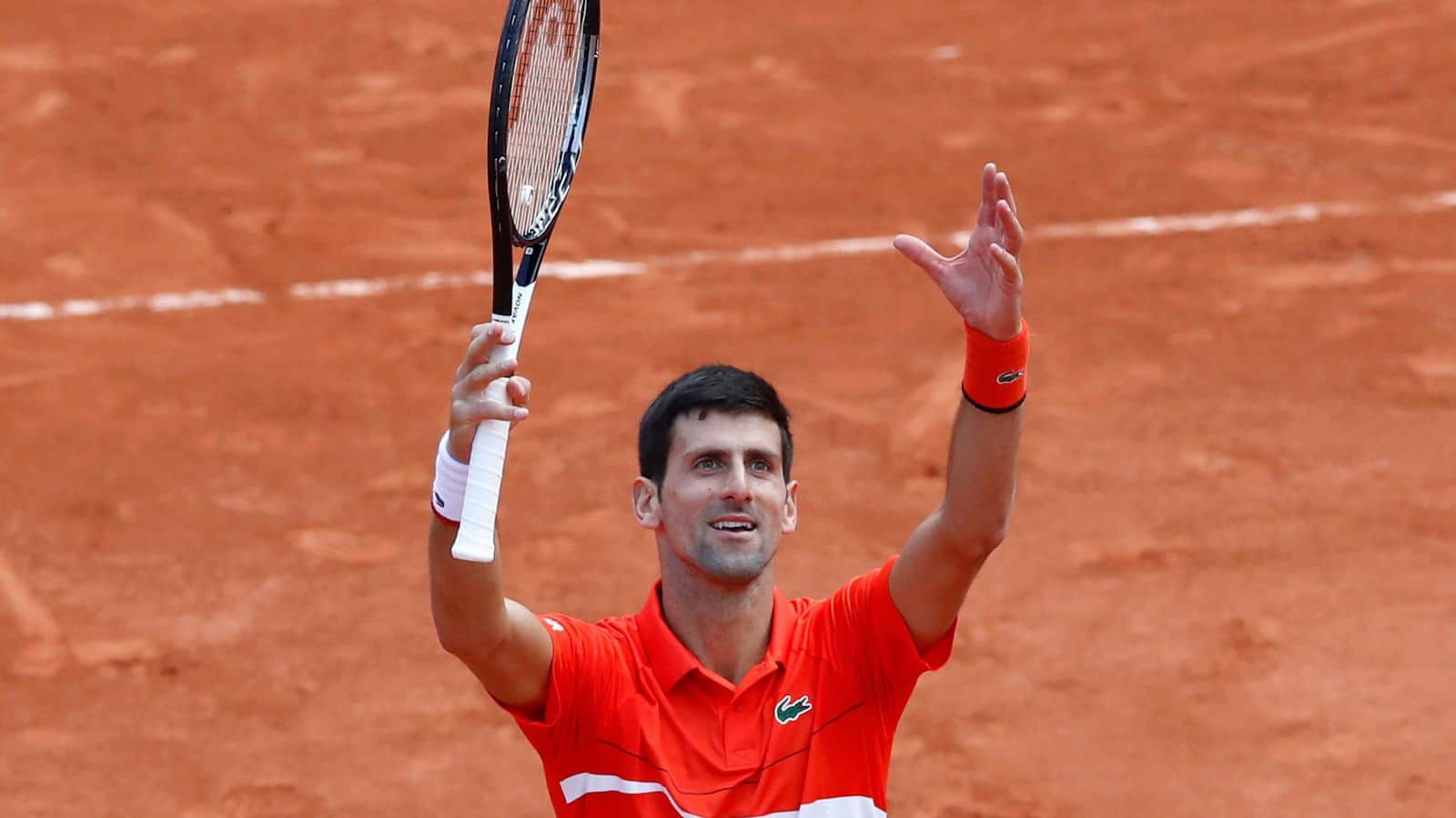 Novak Djokovic celebrates with Serbian fans after his quarter-final victory at the French Open 2021