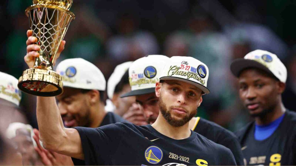 Stephen Curry with Bill Russell Finals MVP trophy