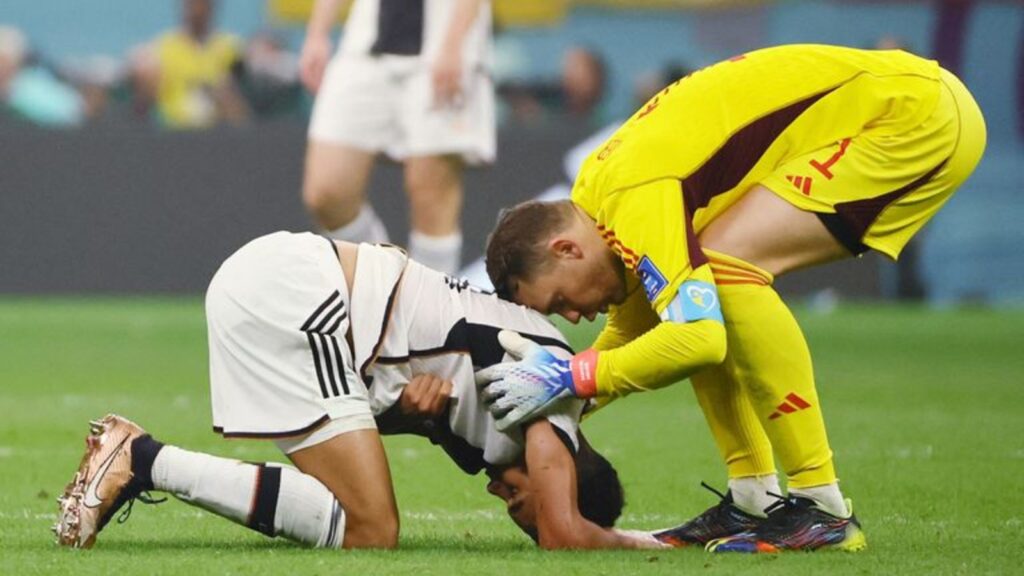 Manuel Neuer consoles Jamal Musiala after the final whistle.