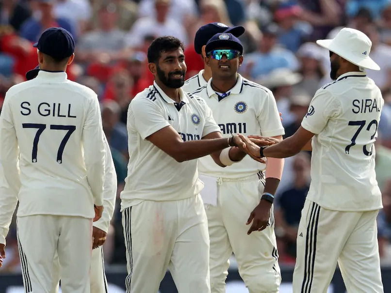 Indian Test team celebrating a wicket taken by Jasprit Bumrah.