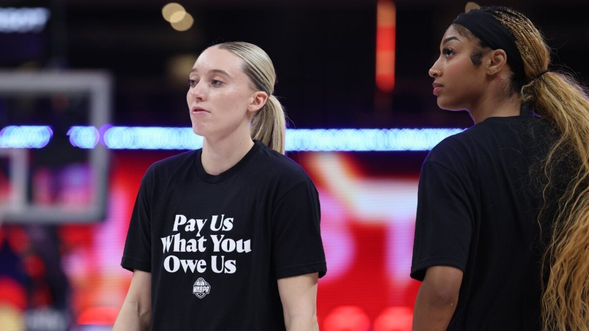 Paige Bueckers and Angel Reese wearing the 'Pay Us' t-shirts