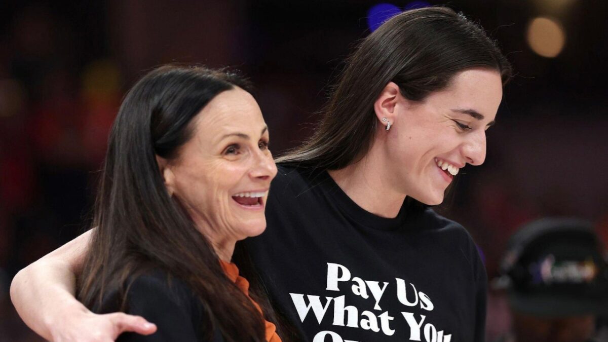 Caitlin Clark wearing the 'Pay Us What You Owe Us' t-shirt