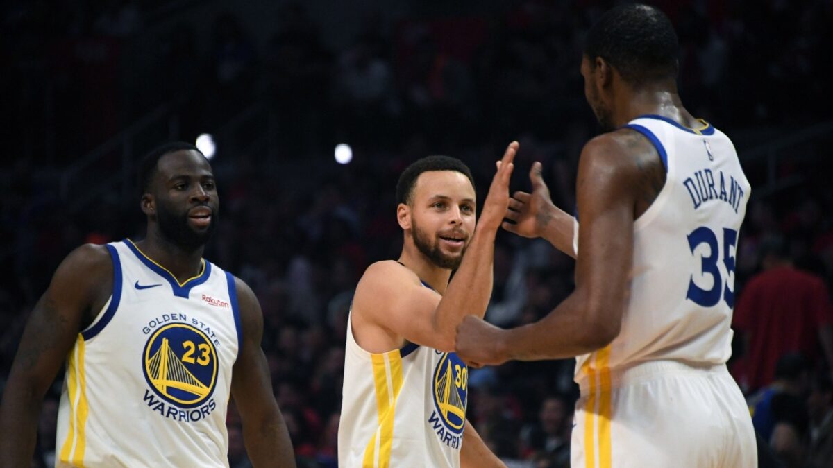 Kevin Durant with Stephen Curry and Draymond Green