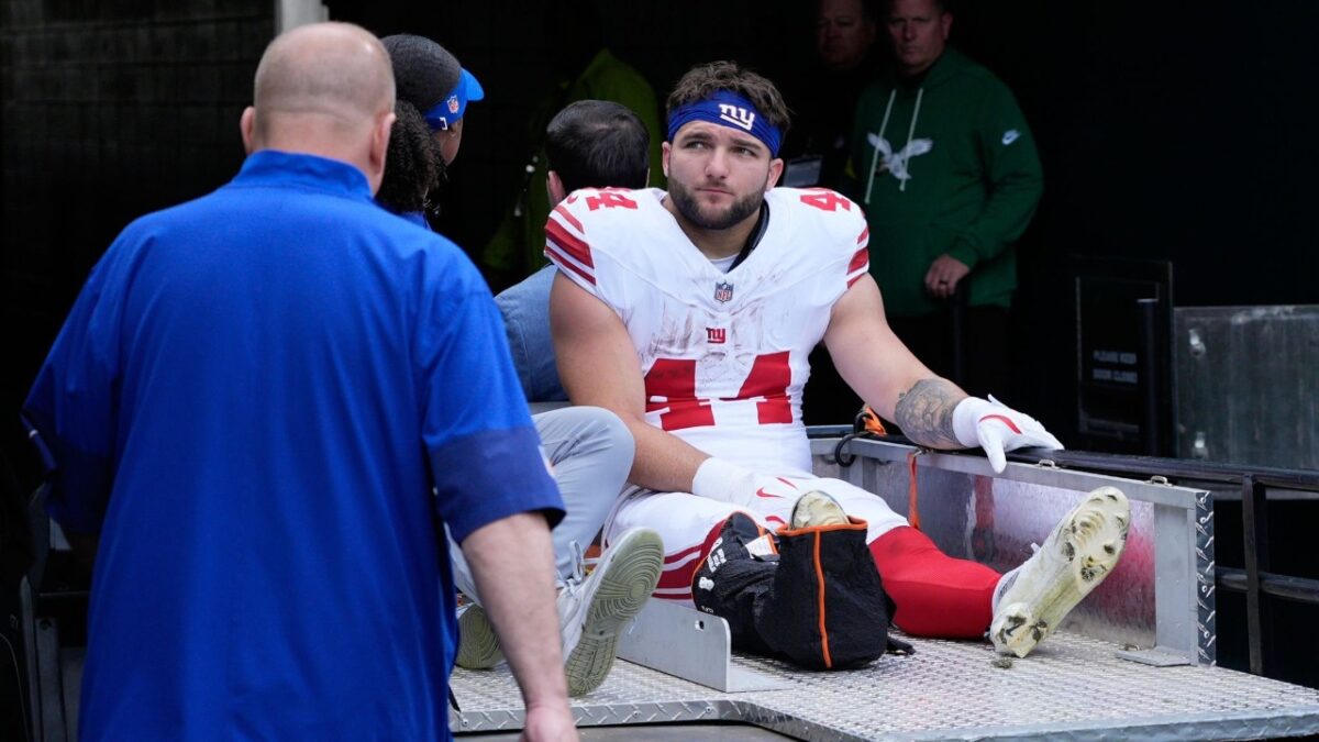 Cam Skattebo being carted off the field