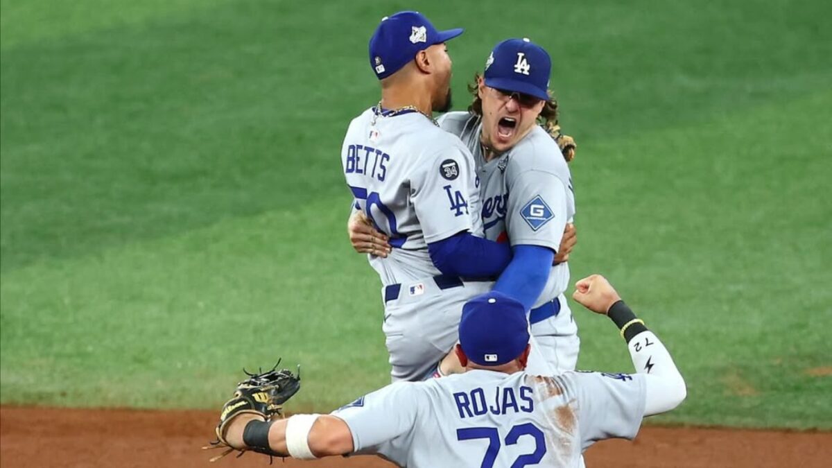 Enrique Hernandez, Mookie Betts and Miguel Rojas celebrating after beating Blue Jays in Game 6