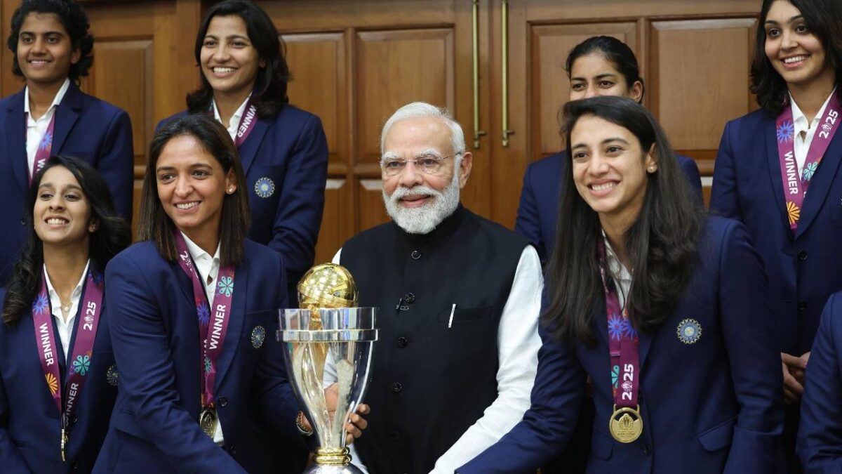 Narendra Modi poses with the World Cup trophy.