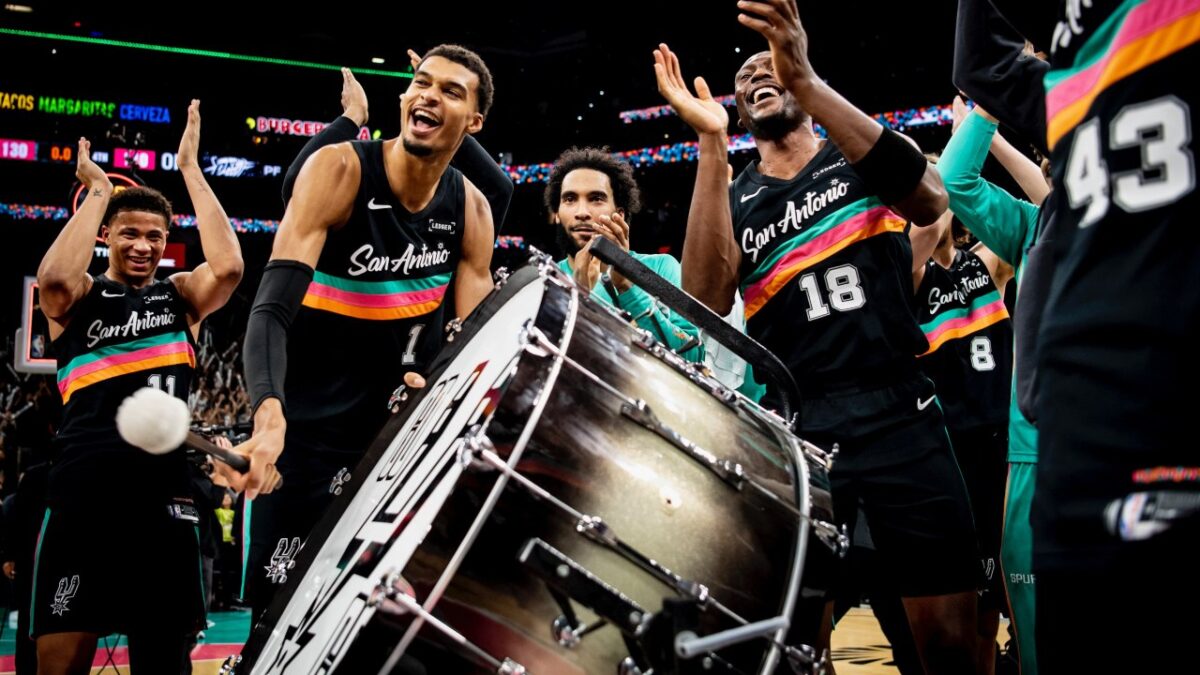 Victor Wembanyama beating the drum to lead fans into the 'Thunder Clap'