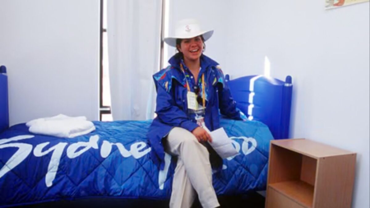 An official sitting in the room provided for athletes at the Sydney Olympic Games Village (Image via The Guardian)