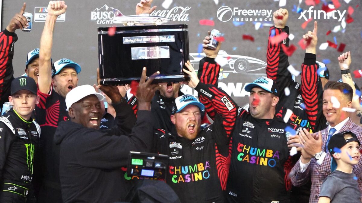Michael Jordan and Tyler Reddick lifting the Daytona 500 trophy