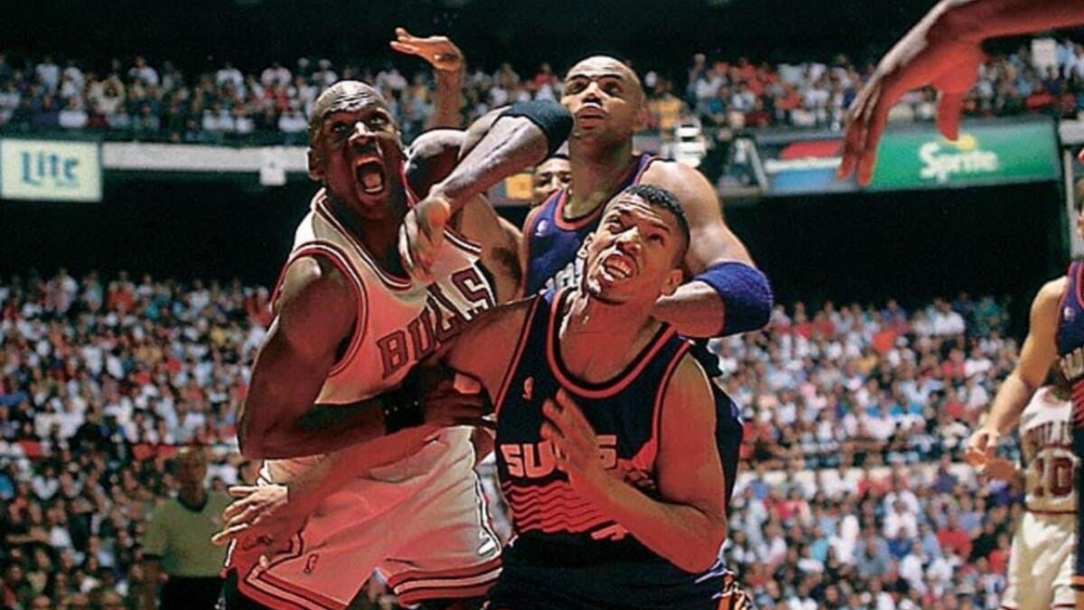 Michael Jordan being guarded by Charles Barkley and Kevin Johnson