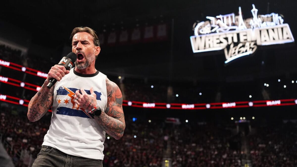 CM Punk on Raw with the WrestleMania sign in the backdrop
