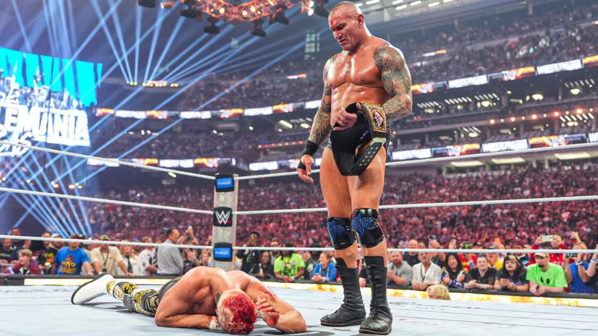 Randy Orton holding the WWE title after punt kicking Cody Rhodes at WrestleMania