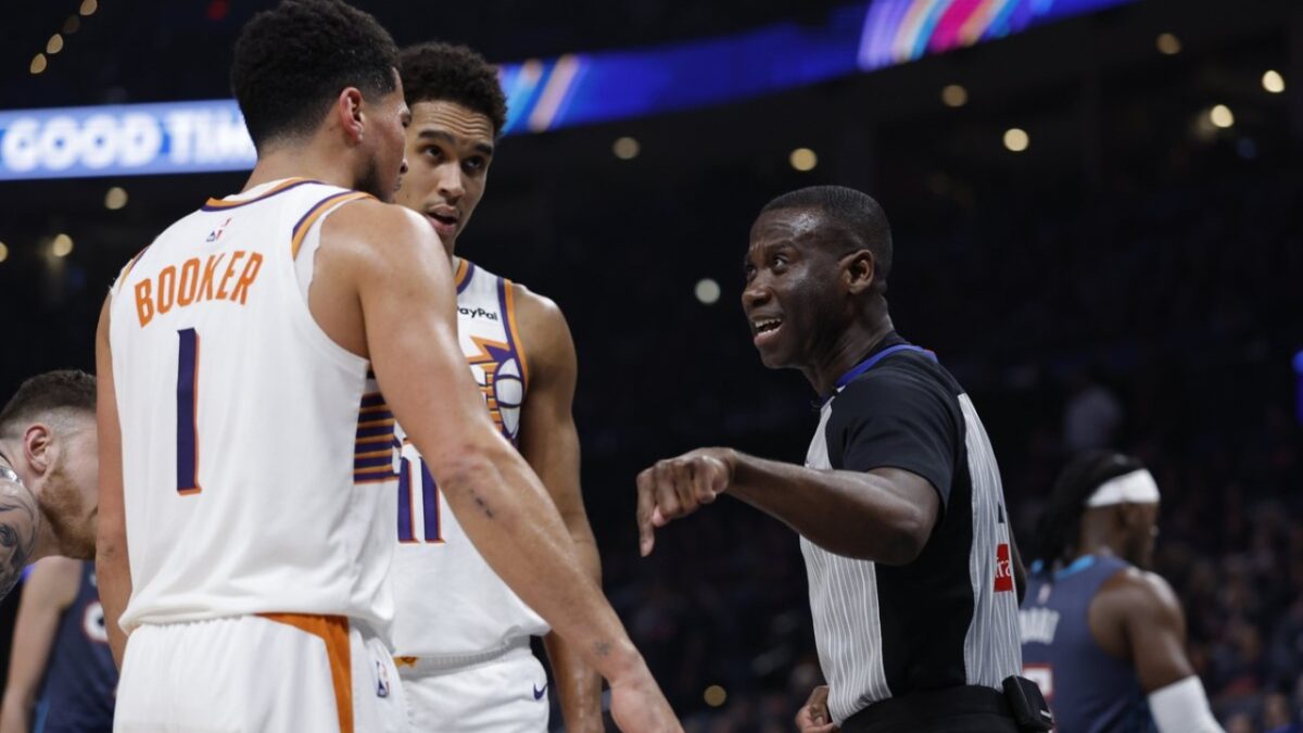 Devin Booker and referee James Williams arguing