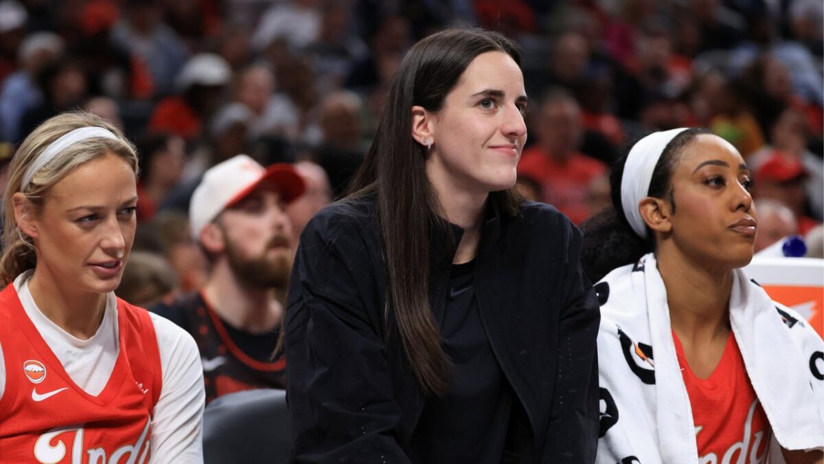 WNBA Warns Fever Over Caitlin Clark Injury Reporting After Fan Fury Led to Empty Seats 1 Caitlin Clark seated on the bench