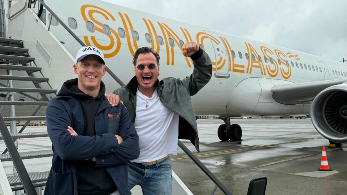 Norway’s History-Making Hockey Team Welcomed Home with Deafening Cheers by Soccer Fans 1 Petter Stordalen and former Norwegian ice hockey player Erik Follestad in front of the Sunclass Airline that flew the Norwegian team back to Oslo (Image via TV2)
